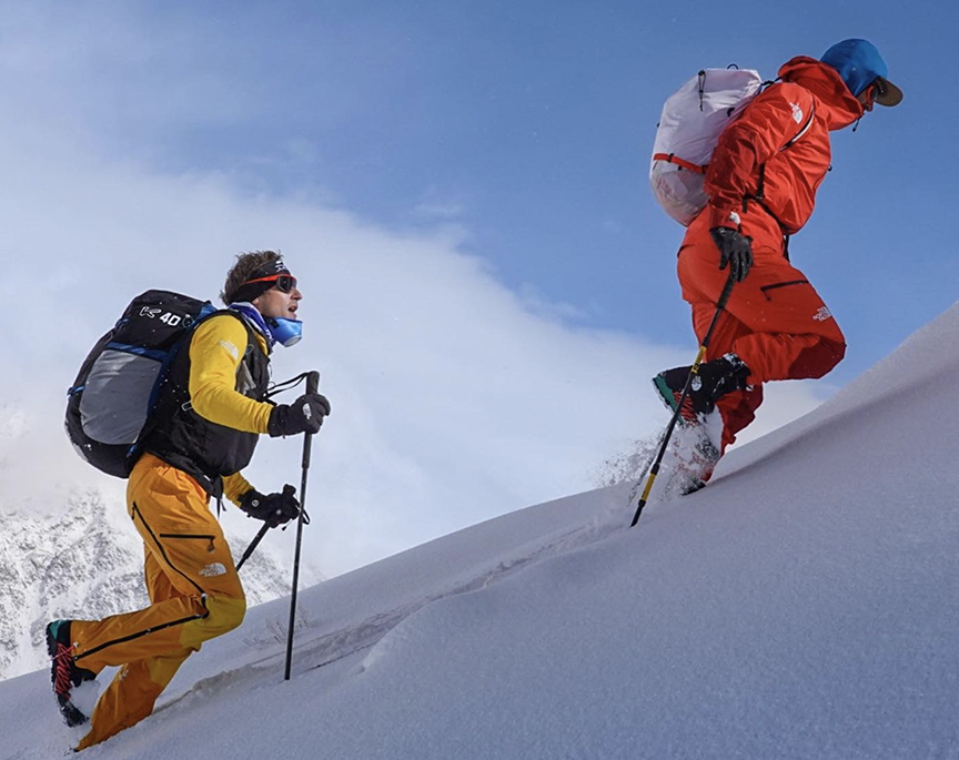 Climbers on a slope of fresh, powdery snow.
